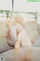 A woman sitting on a couch with her legs crossed.