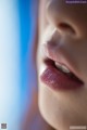 A close up of a child's mouth with a blue background.